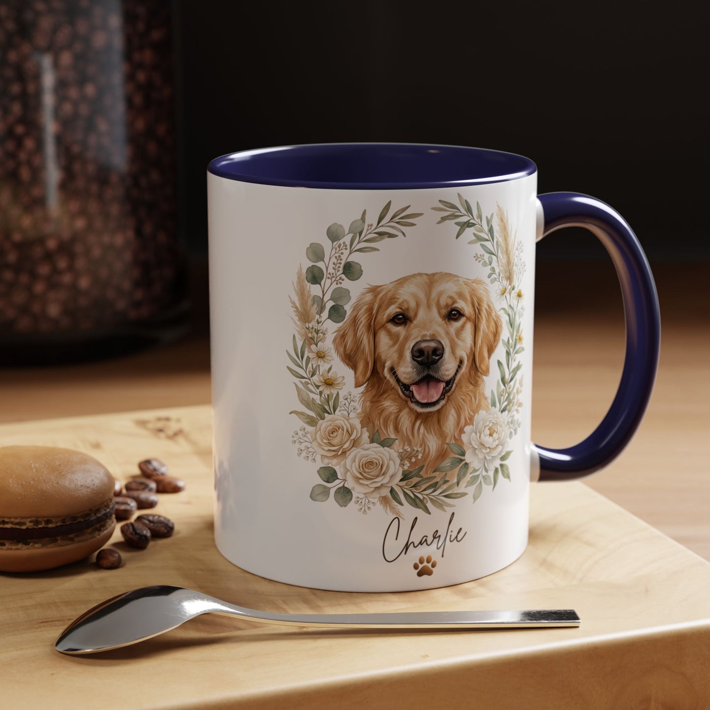 Mug with a dog illustration and floral design on a wooden surface with coffee beans and a macaron.