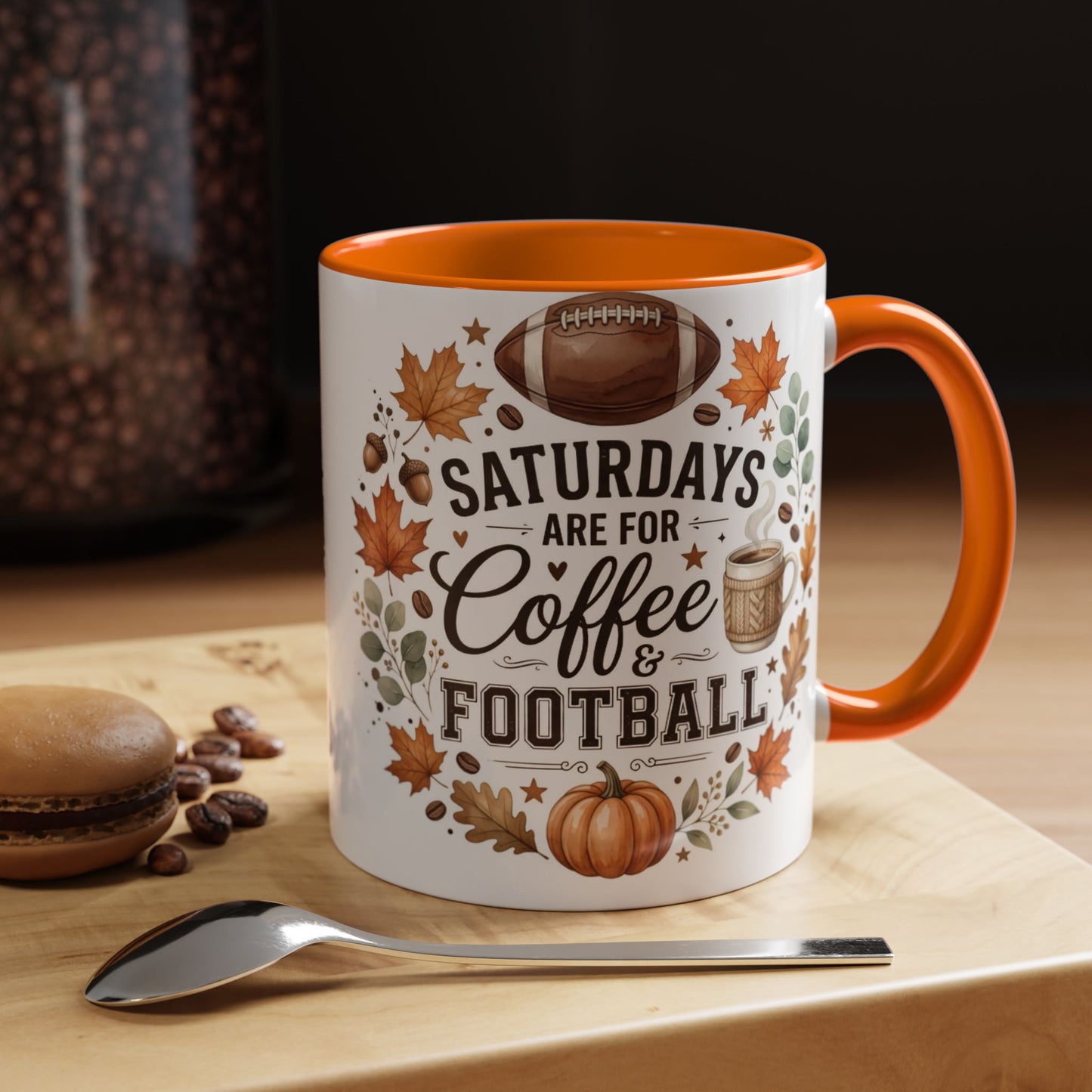 Mug with 'Saturdays are for Coffee & Football' design on a wooden surface with coffee beans and a spoon.