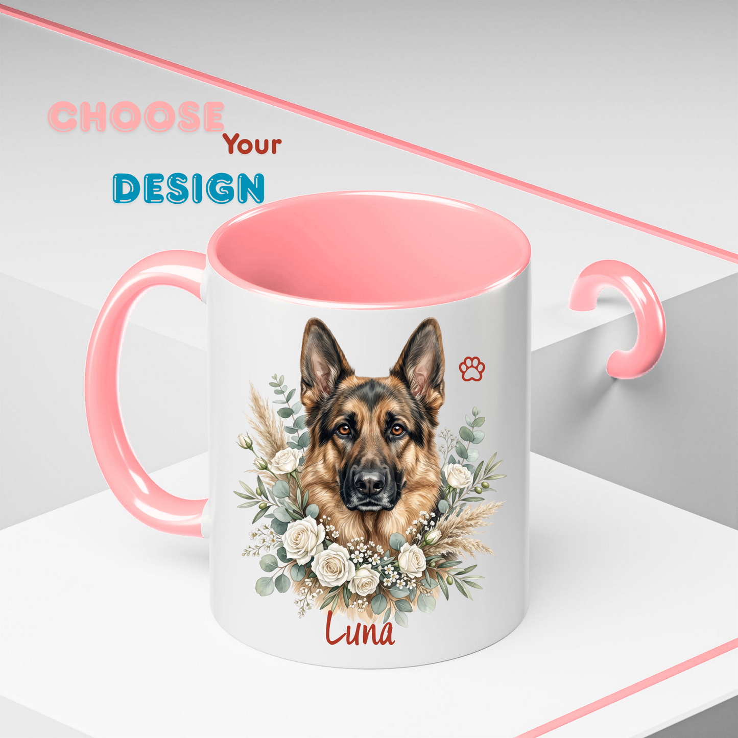 A white ceramic mug with a pink handle and interior, featuring a printed illustration of a German Shepherd dog surrounded by white flowers and greenery, with the name 'Luna' and a small paw print on the front. The mug is shown on a clean white and gray background with decorative pink text reading 'CHOOSE Your DESIGN'.