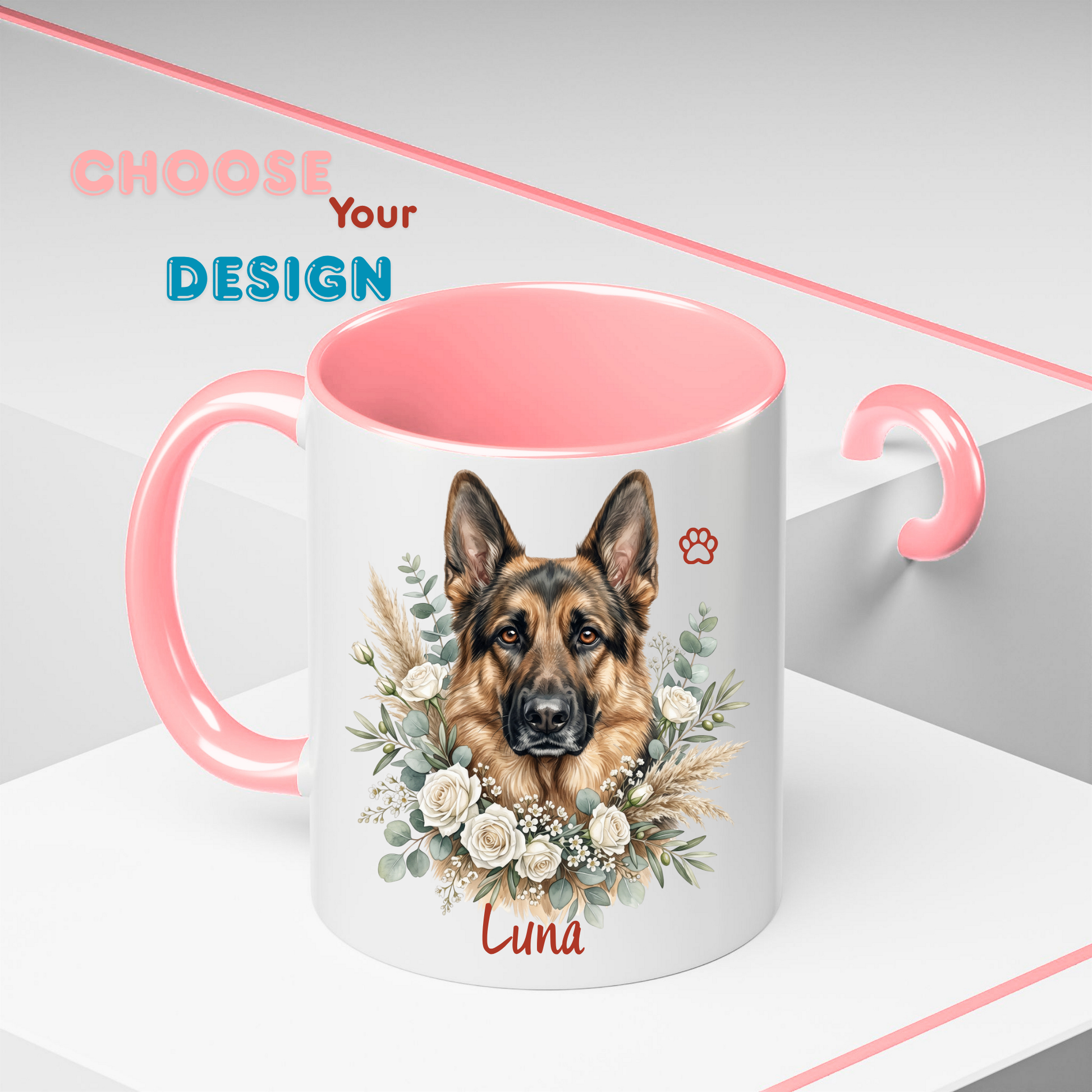A white ceramic mug with a pink handle and interior, featuring a printed illustration of a German Shepherd dog surrounded by white flowers and greenery, with the name 'Luna' and a small paw print on the front. The mug is shown on a clean white and gray background with decorative pink text reading 'CHOOSE Your DESIGN'.