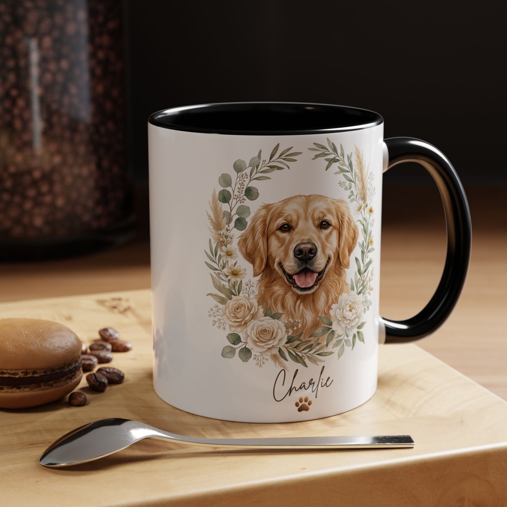 Mug with a dog illustration and floral design on a wooden surface with coffee beans and a macaron.