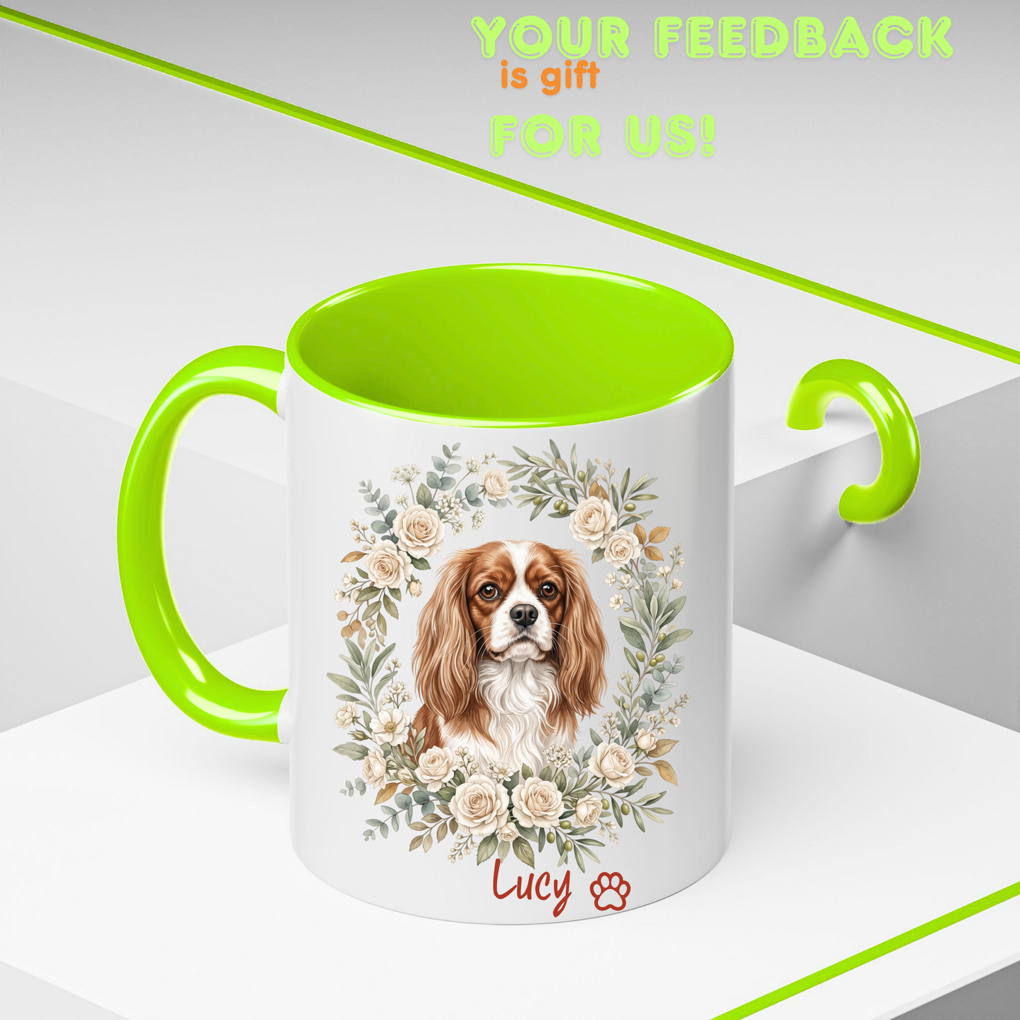 A white ceramic mug with a bright lime green handle and interior, featuring a printed illustration of a Cavalier King Charles Spaniel dog framed by a floral wreath. The name 'Lucy' and a paw print are printed in red near the bottom.